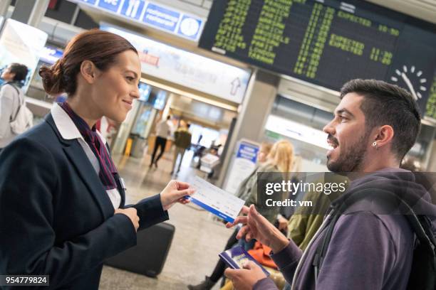 airport attendant helping young hispanic man - asking time stock pictures, royalty-free photos & images