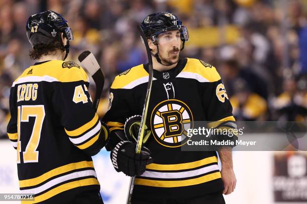 Torey Krug of the Boston Bruins and Brad Marchand look on during the first period of Game Four of the Eastern Conference Second Round against the...
