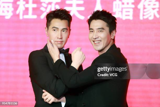 Actor Mark Chao poses with his wax figure during the unveiling ceremony at Madame Tussauds on May 4, 2018 in Shanghai, China.