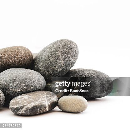 Stack og small rocks on a white table Stack og small rocks on a white table