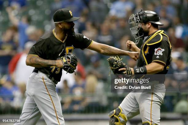 Felipe Vazquez and Francisco Cervelli of the Pittsburgh Pirates celebrate after beating the Milwaukee Brewers 6-4 at Miller Park on May 4, 2018 in...