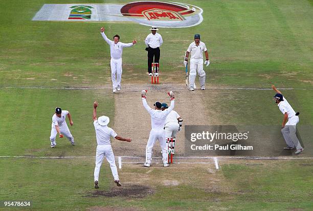 Graeme Swann of England celebrates as Ian Bell catches Ashwell Prince of South Africa for 16 runs during day four of the second test match between...