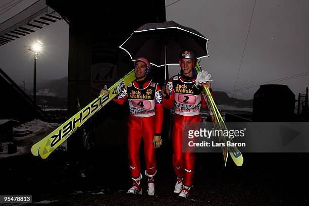 Gregor Schlierenzauer of Austria walks up to the hill with team mate Andreas Kofler prior to the trail round for the FIS Ski Jumping World Cup event...