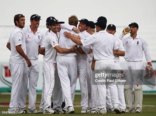 Graeme Swann of England and his team-mates congratulate Stuart Broad on taking the wicket of AB de Villiers of South Africa for 2 runs during day...