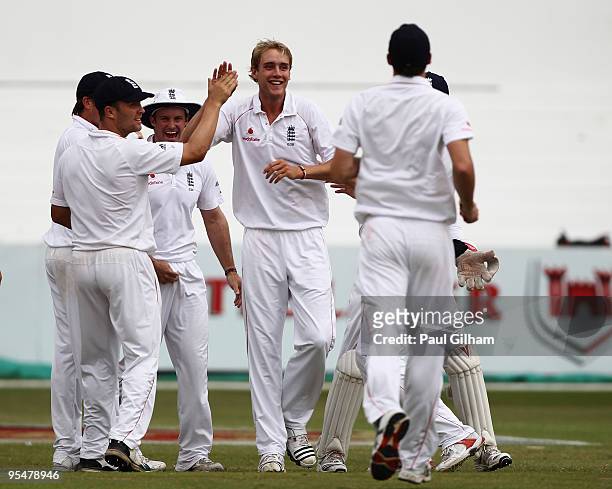 Stuart Broad of England celebrates with his team-mates after taking the wicket of AB de Villiers of South Africa for 2 runs during day four of the...