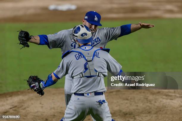Relief pitcher Adam Liberatore of Los Angeles Dodgers celebrates with teammate catcher Yasmani Grandal after winning the MLB game against the San...