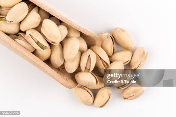 pistachio nut in scoop close up on white background isolated - crack spoon stock pictures, royalty-free photos & images
