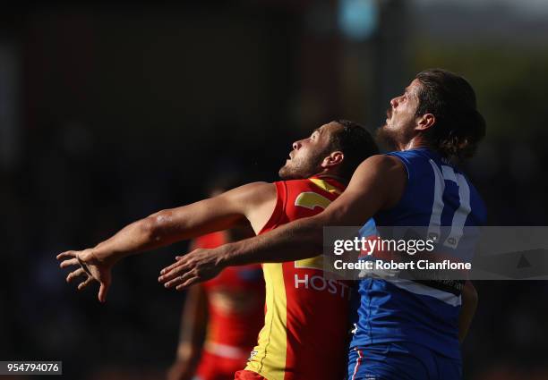 Jarrod Witts of the Suns and Tom Boyd of Footscray compete for the ball during the round seven AFL match between the Western Bulldogs and the Gold...