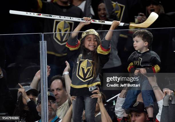 Young fan reacts after receiving a stick from Erik Haula of the Vegas Golden Knights after their victory over the San Jose Sharks in Game Five of the...