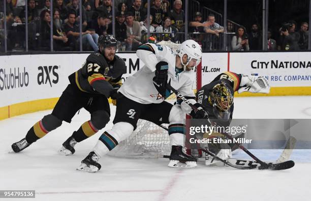 Mikkel Boedker of the San Jose Sharks skates with the puck against Shea Theodore and Marc-Andre Fleury of the Vegas Golden Knights in the third...