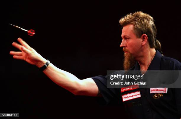 Simon Whitlock of Australia in action against Wayne Jones of England during the 2010 Ladbrokes.com World Darts Championships at Alexandra Palace on...