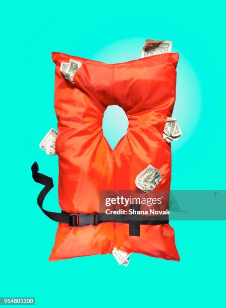 life vest stuffed with money - life jacket stock pictures, royalty-free photos & images