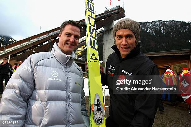 Ralf Schumacher talks to Sven Hannawald during the FIS Ski Jumping World Cup event at the 58th Four Hills ski jumping tournament at Erdinger Arena on...