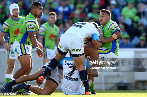 Joshua Papalii of the Raiders is tackled during the round nine NRL match between the Canberra Raiders and the Gold Coast Titans at GIO Stadium on May...