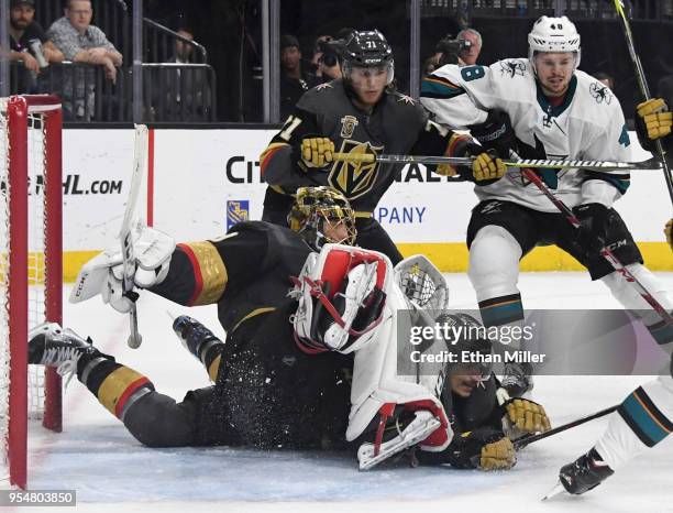 Marc-Andre Fleury of the Vegas Golden Knights falls on top of teammate Luca Sbisa as they defend the net against the San Jose Sharks in the third...