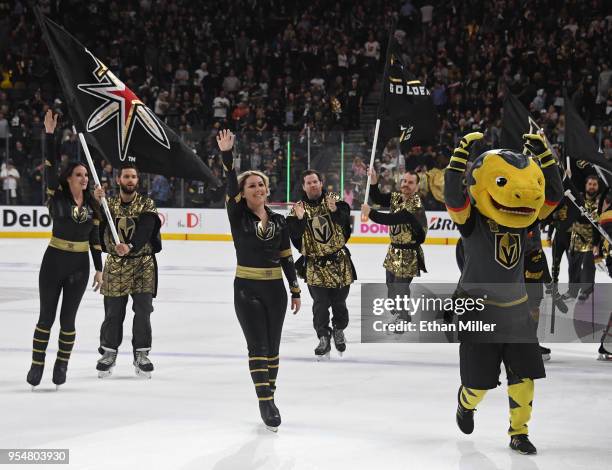 Members of the Knights Crew and the Vegas Golden Knights mascot Chance the Golden Gila Monster celebrate on the ice after the Golden Knights beat the...