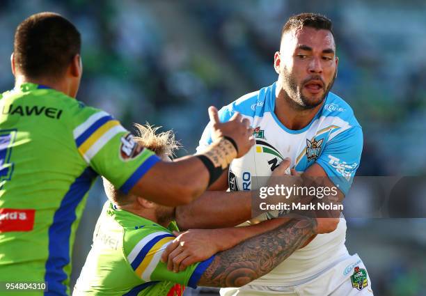 Ryan James of the Titans is tackled during the round nine NRL match between the Canberra Raiders and the Gold Coast Titans at GIO Stadium on May 5,...