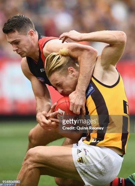 James Worpel of the Hawks is tackled by Conor McKenna of the Bombers during the round seven AFL match between the Essendon Bombers and the Hawthorn...