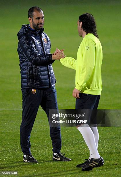 Barcelona´s coach talks with Argentinian defender Gabriel Milito during a training session at Ciutat Esportiva Joan Gamper near Barcelona on December...