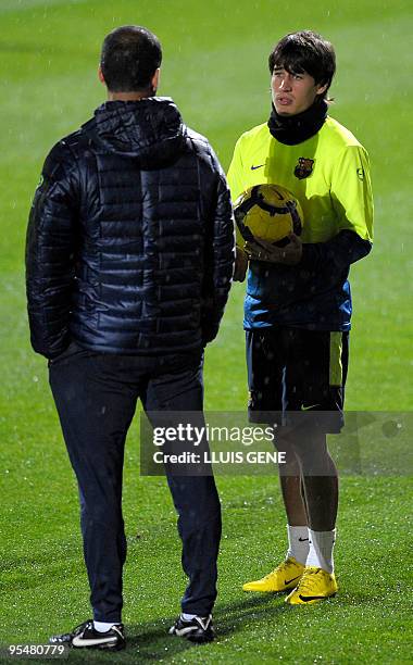 Barcelona´s coach talks with forward Bojan Krkic during a training session at Ciutat Esportiva Joan Gamper near Barcelona on December 29, 2009. AFP...