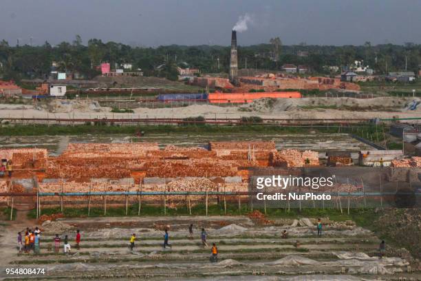 Brick-field workers playing cricket after finish their days work at their brick-field, in Dhaka, Bangladesh, on May 4, 2018.