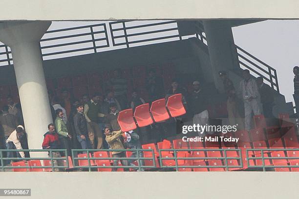 Angry Indian cricket fans show their frustration by destroying property after the cancellation of the fifth and final One Day International cricket...