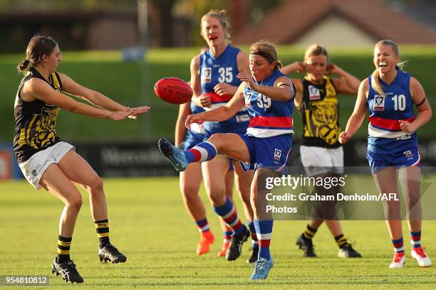 Kerrie Clarke of the Western Bulldogs kicks during the round one AFLW match between the Western Bulldogs and Richmond at Whitten Oval on May 5, 2018...