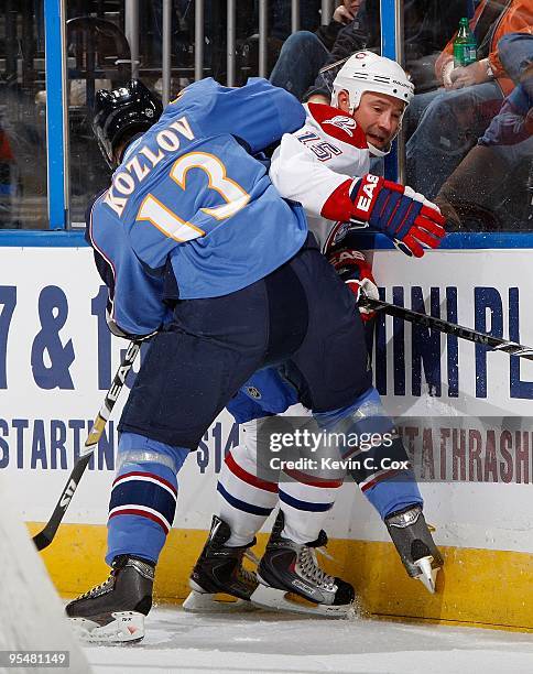 Slava Kozlov of the Atlanta Thrashers against Glen Metropolit of the Montreal Canadiens at Philips Arena on December 12, 2009 in Atlanta, Georgia.