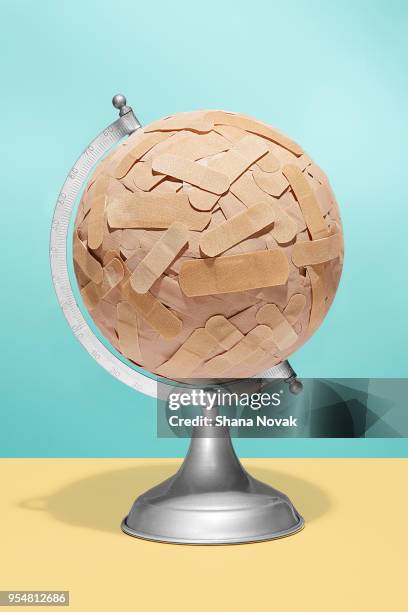 globe covered in bandages - climate change health stock pictures, royalty-free photos & images