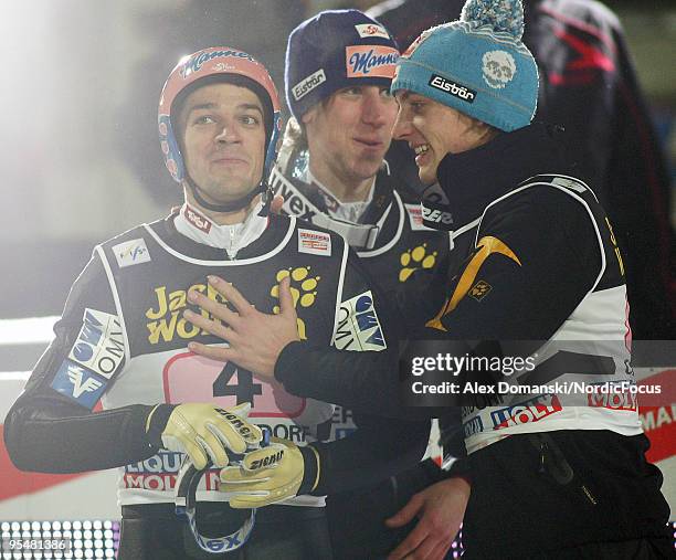 Andreas Kofler celebrates with Martin Koch and Gregor Schlierenzauer of Austria after winning the FIS Ski Jumping World Cup event at the 58th Four...