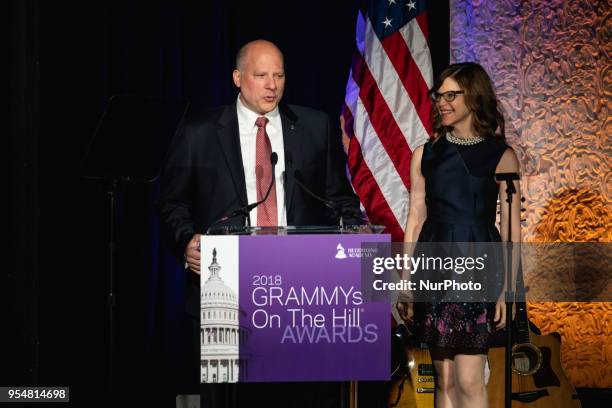 John Poppo, Chair of the Board for The Recording Academy speaks, as Recording artist Lisa Loeb stands by, at The Recording Academy's Grammys on the...