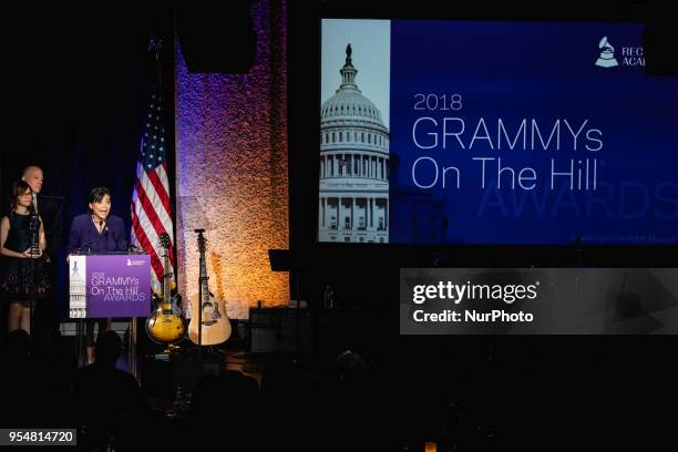 Rep. Judy Chu accepts her award, with John Poppo, Chair of the Board for The Recording Academy, and recording artist Lisa Loeb standing by her side,...