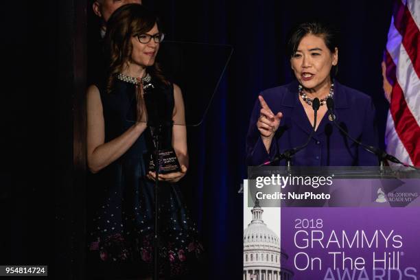 Rep. Judy Chu accepts her award, with John Poppo, Chair of the Board for The Recording Academy, and recording artist Lisa Loeb standing by her side,...