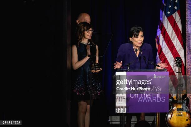 Rep. Judy Chu accepts her award, with John Poppo, Chair of the Board for The Recording Academy, and recording artist Lisa Loeb standing by her side,...