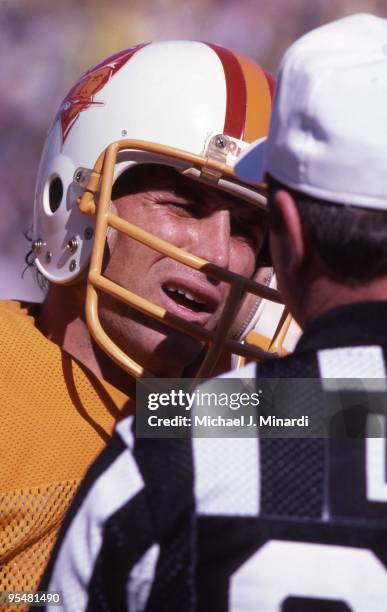 Quarterback Steve Young of the Tampa Bay Buccaneers disputes a call with an umpire in a NFL game against the Minnesota Vikings at Tampa Stadium on...