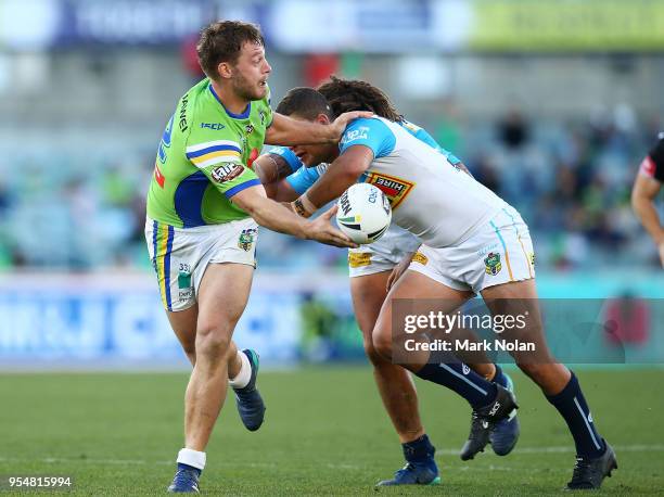 Elliot Whitehead of the Raiders offloads during the round nine NRL match between the Canberra Raiders and the Gold Coast Titans at GIO Stadium on May...