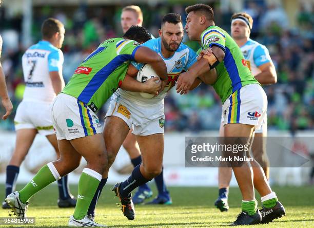 Ryan James of the Titans is tackled during the round nine NRL match between the Canberra Raiders and the Gold Coast Titans at GIO Stadium on May 5,...