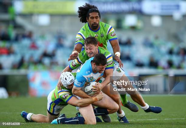 Anthony Don of the Titans is tackled during the round nine NRL match between the Canberra Raiders and the Gold Coast Titans at GIO Stadium on May 5,...