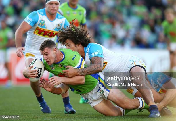 Luke Bateman of the Raiders is tackled during the round nine NRL match between the Canberra Raiders and the Gold Coast Titans at GIO Stadium on May...