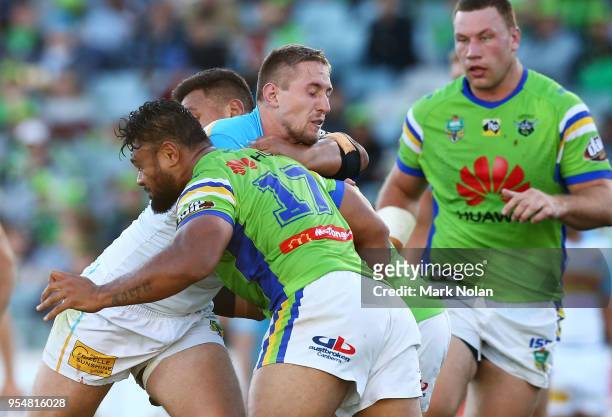 Jack Stockwell of the Titans is tackled during the round nine NRL match between the Canberra Raiders and the Gold Coast Titans at GIO Stadium on May...