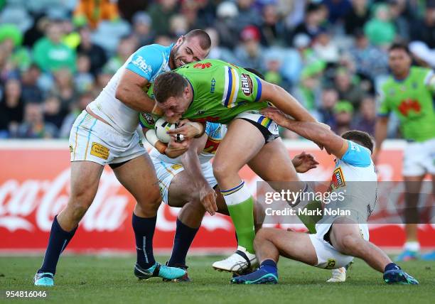 Shannon Boyd of the Raiders is tackled during the round nine NRL match between the Canberra Raiders and the Gold Coast Titans at GIO Stadium on May...