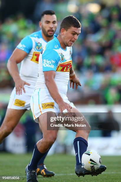 Ashley Taylor of the Titans kicks ahead during the round nine NRL match between the Canberra Raiders and the Gold Coast Titans at GIO Stadium on May...