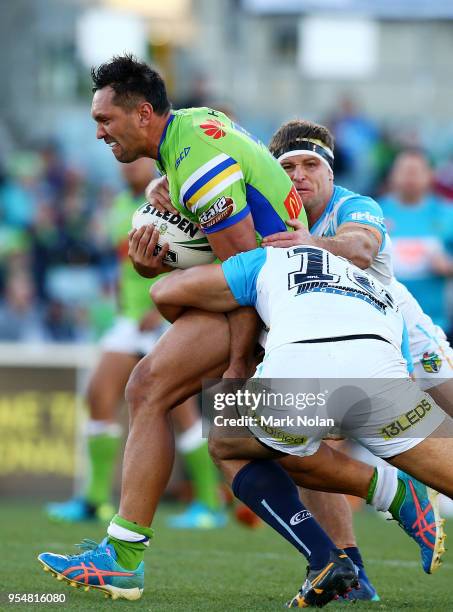 Jordan Rapana of the Raiders is tackled during the round nine NRL match between the Canberra Raiders and the Gold Coast Titans at GIO Stadium on May...