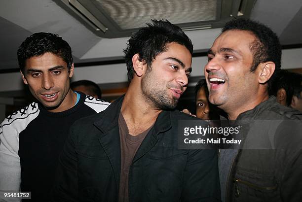 Cricketers Ashish Nehra, Virat Kohli and Virender Sehwag at a party in the honour of Virender Sehwag following his stupendous Test performance...
