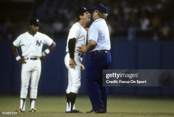 S: Manager Billy Martin of the New York Yankees arguing with an umpire as second baseman Willie Randolph looks on during a MLB baseball game circa...