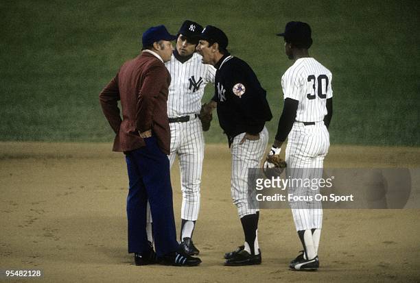 S: Manager Billy Martin of the New York Yankees arguing with the second base umpire as Willie Randolph and shortstop Bucky Dent looks on during a MLB...