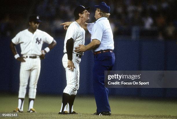 S: Manager Billy Martin of the New York Yankees arguing with an umpire as second baseman Willie Randolph looks on during a MLB baseball game circa...