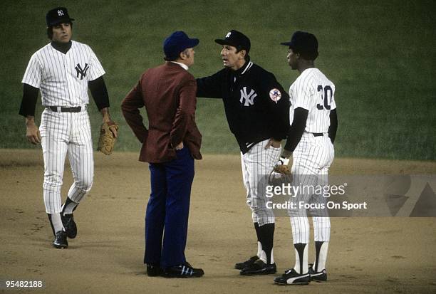 S: Manager Billy Martin of the New York Yankees arguing with the second base umpire as Willie Randolph and shortstop Bucky Dent looks on during a MLB...