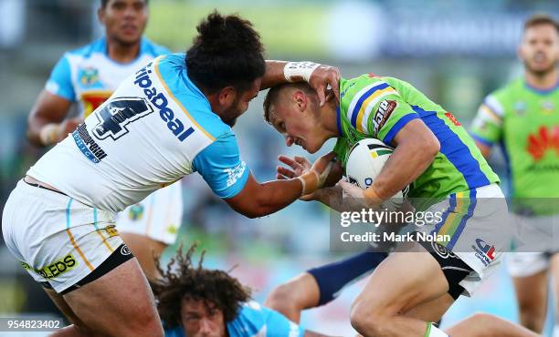 Jack Wighton of the Raiders is tackled during the round nine NRL match between the Canberra Raiders and the Gold Coast Titans at GIO Stadium on May...