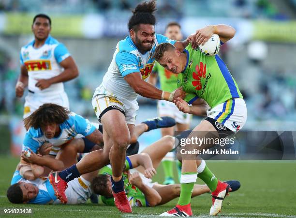 Jack Wighton of the Raiders is tackled during the round nine NRL match between the Canberra Raiders and the Gold Coast Titans at GIO Stadium on May...